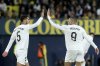 Real Madrid's Kylian Mbappe celebrates with Jude Bellingham, left, after scoring his side's second goal during a Spanish La Liga soccer match between Villarreal and Real Madrid in Villarreal, Spain, Saturday, March 15, 2025. (AP Photo/Alberto Saiz)