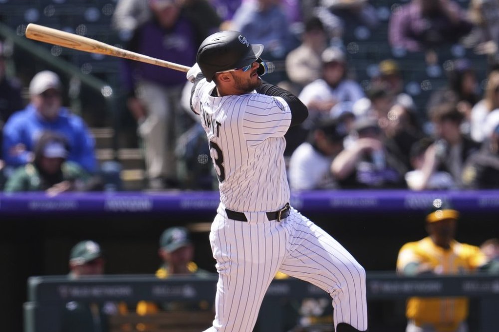 Colorado Rockies' Kris Bryant doubles against Athletics starting pitcher Joey Estes in the third inning of a baseball game Sunday, April 6, 2025, in Denver. (AP Photo/David Zalubowski)