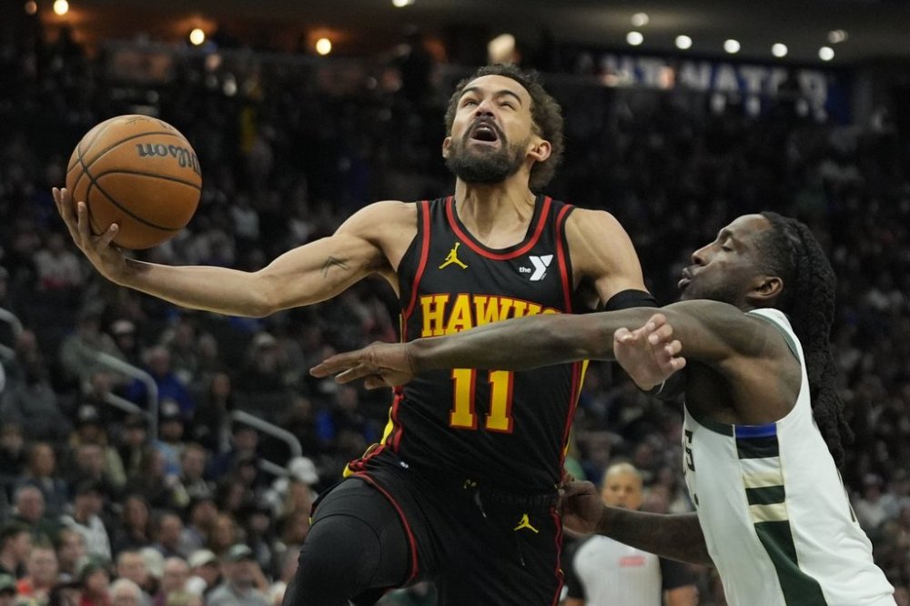 Atlanta Hawks' Trae Young (11) drives to the basket against Milwaukee Bucks' Taurean Prince, right, during the first half of an NBA basketball game Sunday, March 30, 2025, in Milwaukee. (AP Photo/Aaron Gash)