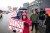 People attend a protest rally outside a Telsa dealership in Ottawa against CEO Elon Musk's political influence on March 22, 2025. THE CANADIAN PRESS/Justin Tang