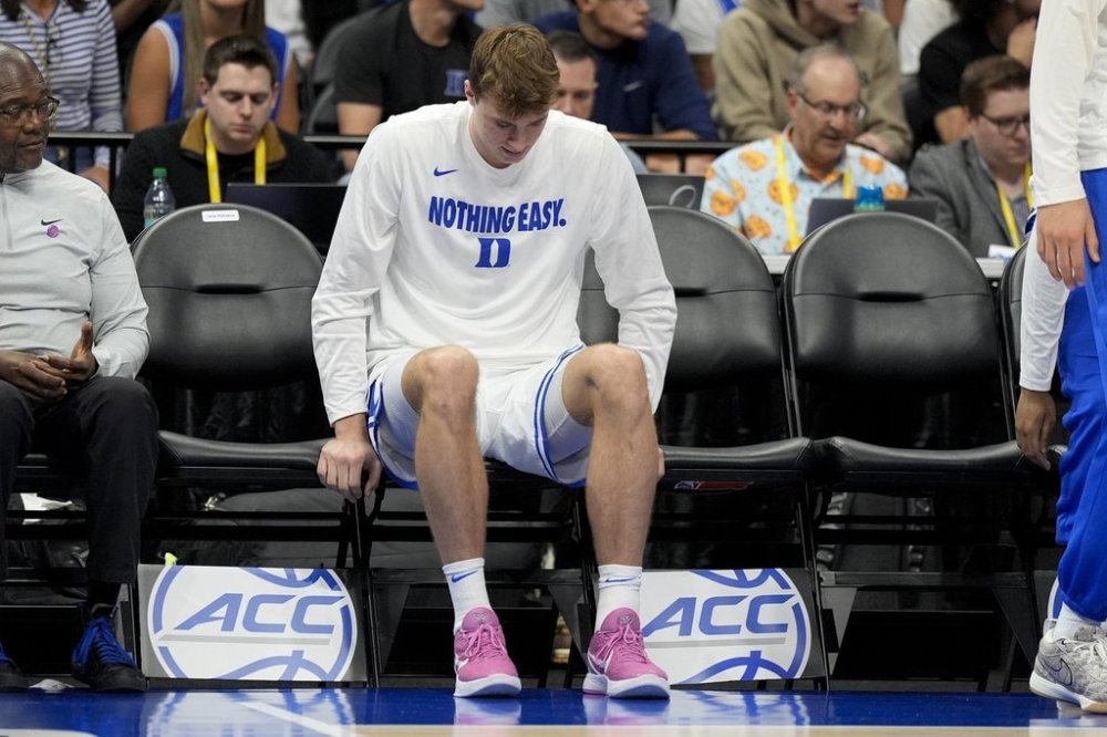 Duke forward Cooper Flagg sits on the bench during the second half of an NCAA college basketball game against Georgia Tech in the quarterfinals of the Atlantic Coast Conference tournament, Thursday, March 13, 2025, in Charlotte, N.C. Flagg was injured in the first half. (AP Photo/Chris Carlson)