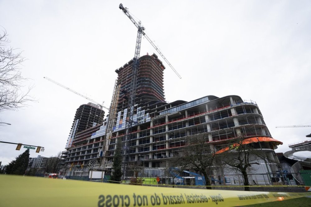 WorkSafeBC says a worker killed in Vancouver last year when a concrete mould fell 26 storeys shouldn’t have been able to stand where she was. A load on a crane fell from the top of the building smashing multiple floors of the Oakridge Mall construction in Vancouver, B.C., on Feb. 21, 2024. THE CANADIAN PRESS/Ethan Cairns