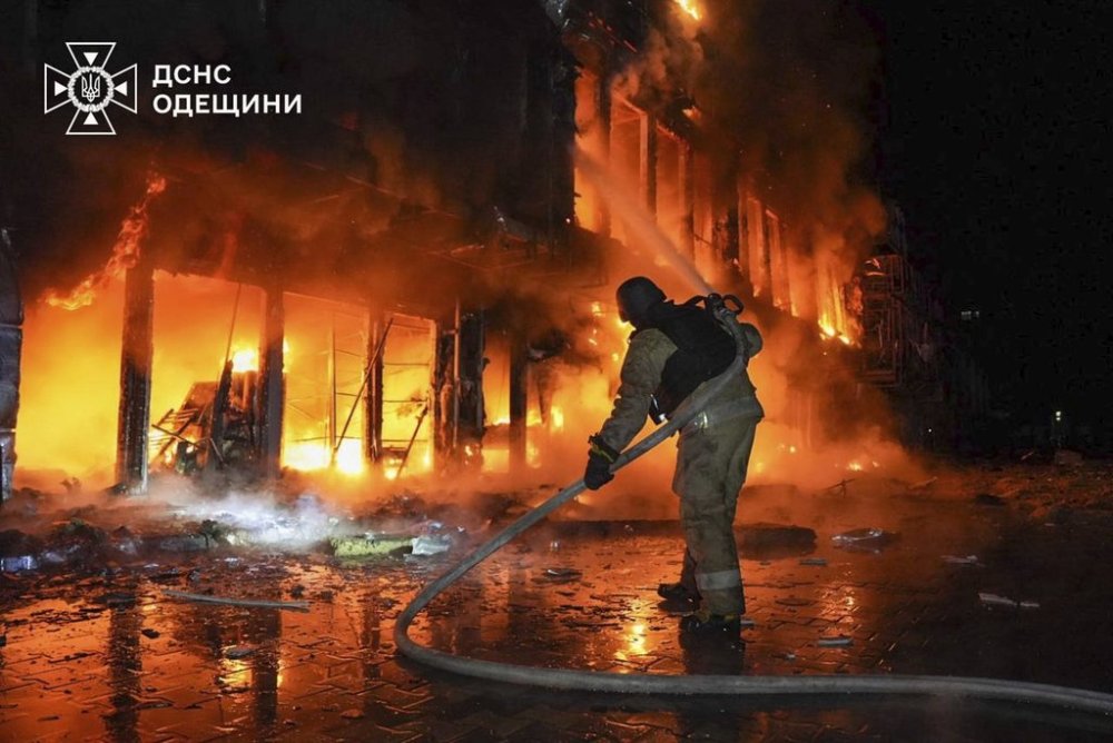 In this photo provided by the Ukrainian Emergency Service, firefighters put out the fire at a storehouse following a Russian attack in Odesa, Ukraine, Friday, March 21, 2025. (Ukrainian Emergency Service via AP)