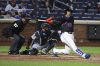 New York Mets' Juan Soto (22) hits a single during the seventh inning of a baseball game against the Miami Marlins, Monday, April 7, 2025, in New York. (AP Photo/Pamela Smith)