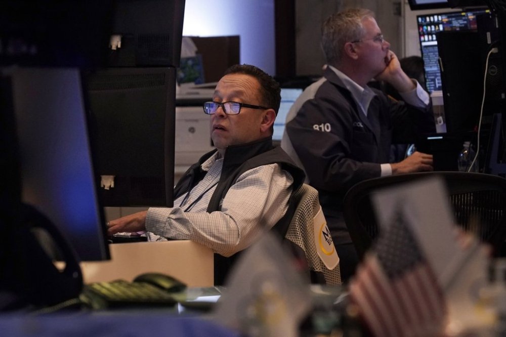 A pair of traders work on the floor of the New York Stock Exchange, Tuesday, March 11, 2025. (AP Photo/Richard Drew)