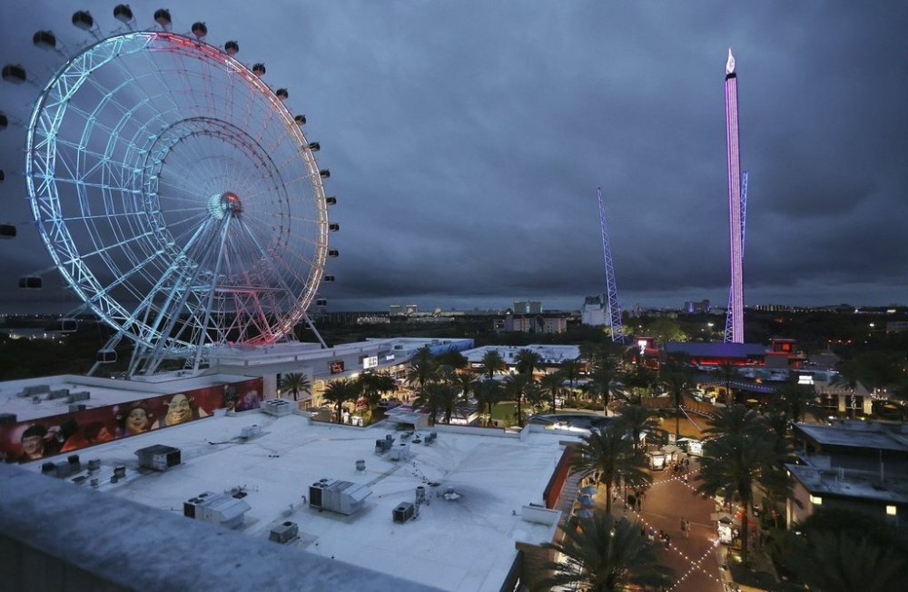 FILE - ICON Park attractions, The Wheel, left, Orlando SlingShot, middle, and Orlando FreeFall, right, are shown in Orlando, Fla., on Thursday, March 24, 2022. (Stephen M. Dowell /Orlando Sentinel via AP, File)