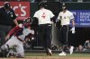 Texas Rangers' Joc Pederson (4) and Josh Jung (6) celebrate after Pederson scored on a Jake Burger double as Boston Red Sox's Connor Wong, second from left, holds the ball by the plate in the sixth inning of a baseball game, Friday, March 28, 2025, in Arlington, Texas. (AP Photo/Tony Gutierrez)