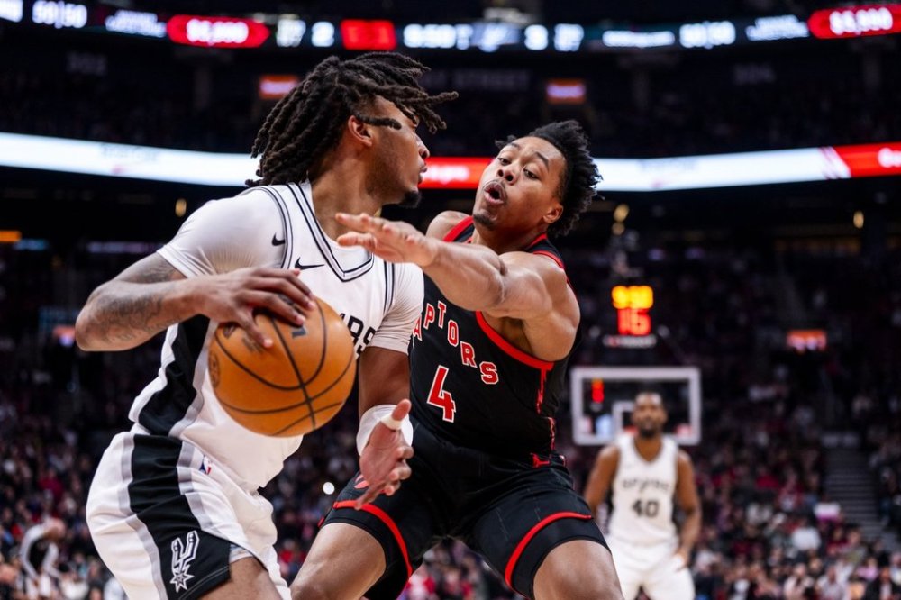 Toronto Raptors forward Scottie Barnes (4) defends against San Antonio Spurs guard Stephon Castle (5) during the first half of NBA basketball action in Toronto on Sunday, March 23, 2025. THE CANADIAN PRESS/Thomas Skrlj