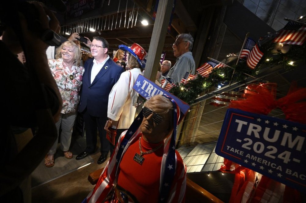 Republican candidate Randy Fine, second from left, meets with supporters after the special election for U.S. House District 6 was called in his favor, Tuesday, April 1, 2025 in Ormond Beach, Fla. (AP Photo/Phelan M. Ebenhack)