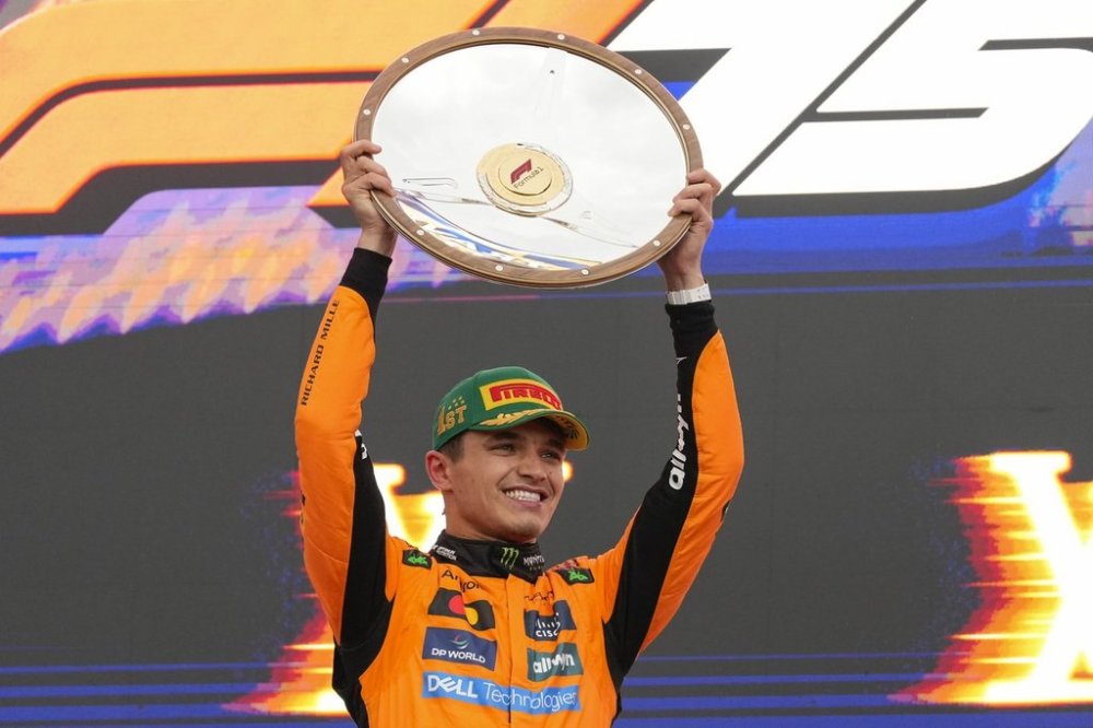 McLaren driver Lando Norris of Britain celebrates on the podium after winning the Australian Formula One Grand Prix at Albert Park, in Melbourne, Australia, Sunday, March 16, 2025. (AP Photo/Asanka Brendon Ratnayake)