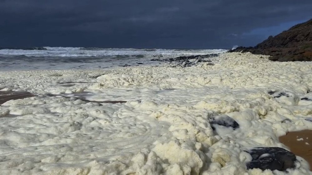 This image made from video provided by Australian Broadcasting Corp., shows foam washing up on beach Monday, March 17, 2025, in Waitpinga, near Adelaide. (Australian Broadcasting Corp via AP)