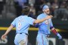 Texas Rangers' Josh Smith (8) congratulates teammate Jonah Heim, right, after Heim singled to score him during the ninth inning of a baseball game against the Tampa Bay Rays, Sunday, April 6, 2025, in Arlington, Texas. (AP Photo/LM Otero)