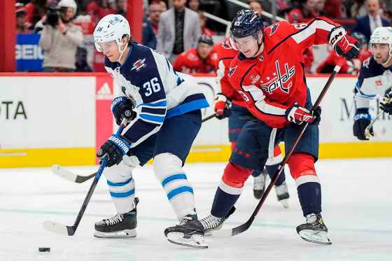 During a matchup between the two teams last season, Winnipeg Jets centre Morgan Barron (36) skates with puck ahead of Washington Capitals left wing Ivan Miroshnichenko (63) on March 24, 2024 in Washington. (Mark Schiefelbein / The Associated Press files)
