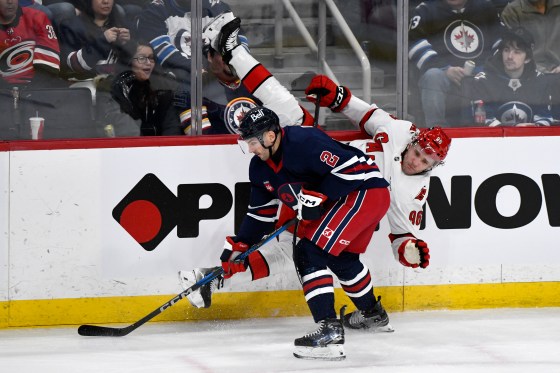 Carolina Hurricanes' Mikko Rantanen (96) is checked by Winnipeg Jets' Dylan Demelo (2) during the Feb. 4 game. (Fred Greenslade / Canadian Press files)
