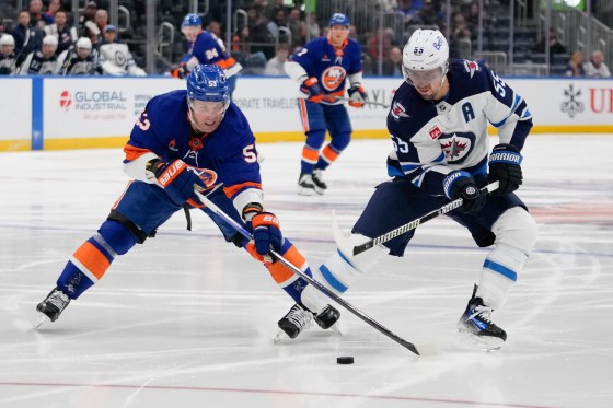 New York Islanders' Casey Cizikas (53) fights for control of the puck with Winnipeg Jets' Mark Scheifele (55) during the March 4 game. (Frank Franklin II / Associated Press files)