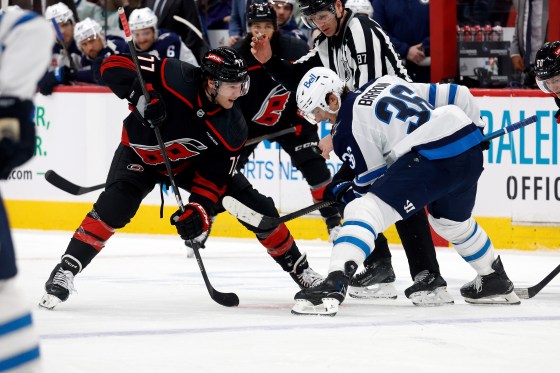 Carolina Hurricanes' Mark Jankowski (77) faces off against Winnipeg Jets' Morgan Barron (36) during Sunday's game. (Karl DeBlaker / The Associated Press files)