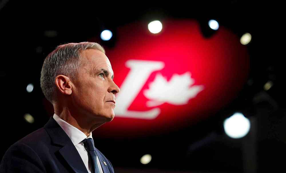 Liberal Party of Canada leadership candidate Mark Carney looks on as Prime Minister Justin Trudeau delivers a speech during the Liberal leadership announcement in Ottawa on Sunday, March 9, 2025. THE CANADIAN PRESS/Sean Kilpatrick