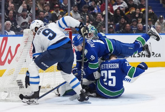 Vancouver Canucks' Elias Pettersson (40) collides with Elias Pettersson (25) in front of goalie Kevin Lankinen, back right, after Winnipeg Jets' Alex Iafallo (9) scored during the March 18 matchup between the two teams. (Darryl Dyck / The Canadian Press files)