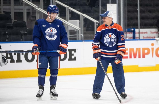 Prime Minister Mark Carney (right) skates with Derek Ryan at the Edmonton Oilers practice during a visit to Edmonton on Thursday. (Jason Franson / The Canadian Press)