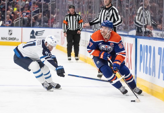 Winnipeg Jets' Cole Perfetti (91) chases Edmonton Oilers' Connor McDavid (97) in Edmonton on Thursday. (Jason Franson / The Canadian Press files)