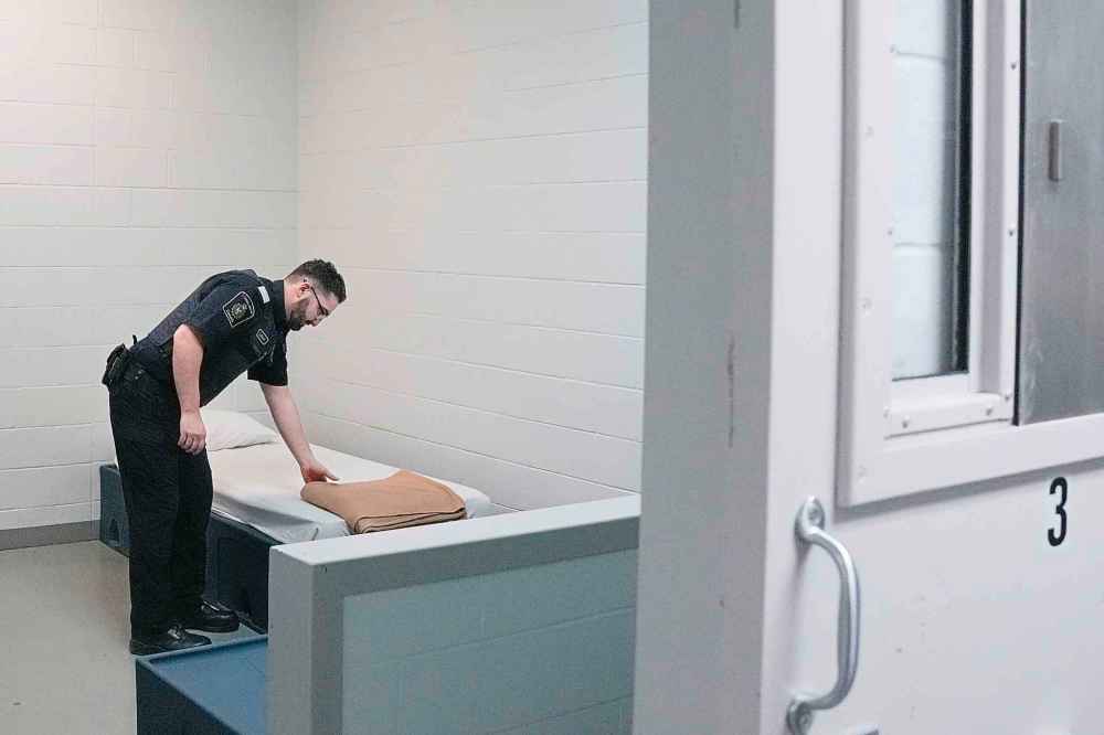 A Canada Border Services Agency staff member is seen in a wet cell at the CBSA's GTA Immigration Holding Centre in Toronto, Wednesday, Feb. 19, 2025. THE CANADIAN PRESS/Chris Young