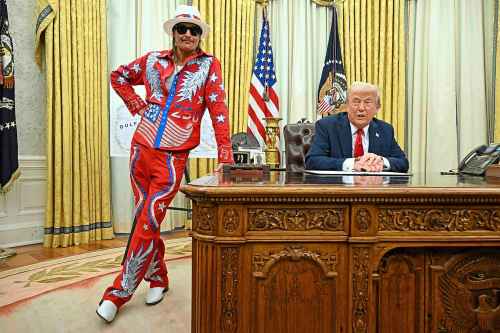 President Donald Trump speaks to reporters before signing an executive order in the Oval Office of the White House in Washington, Monday, March 31, 2025, as Kid Rock listens. (Pool via AP)