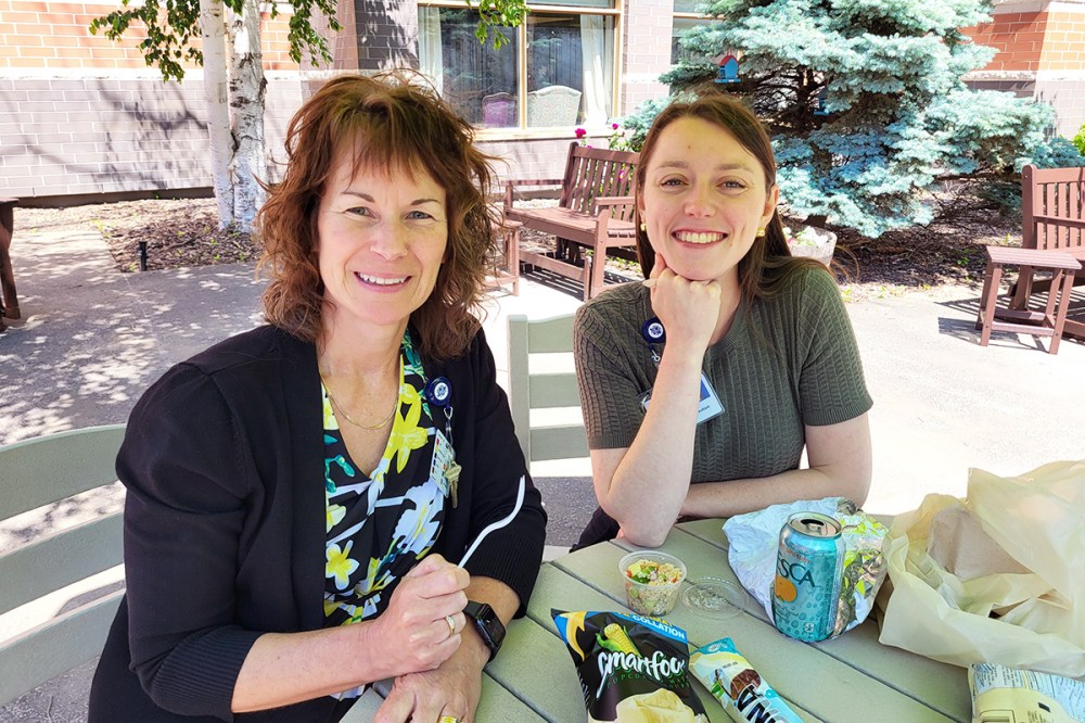 Employees at Riverview Health Centre enjoy a sunny lunch together in the organization’s campus courtyard.