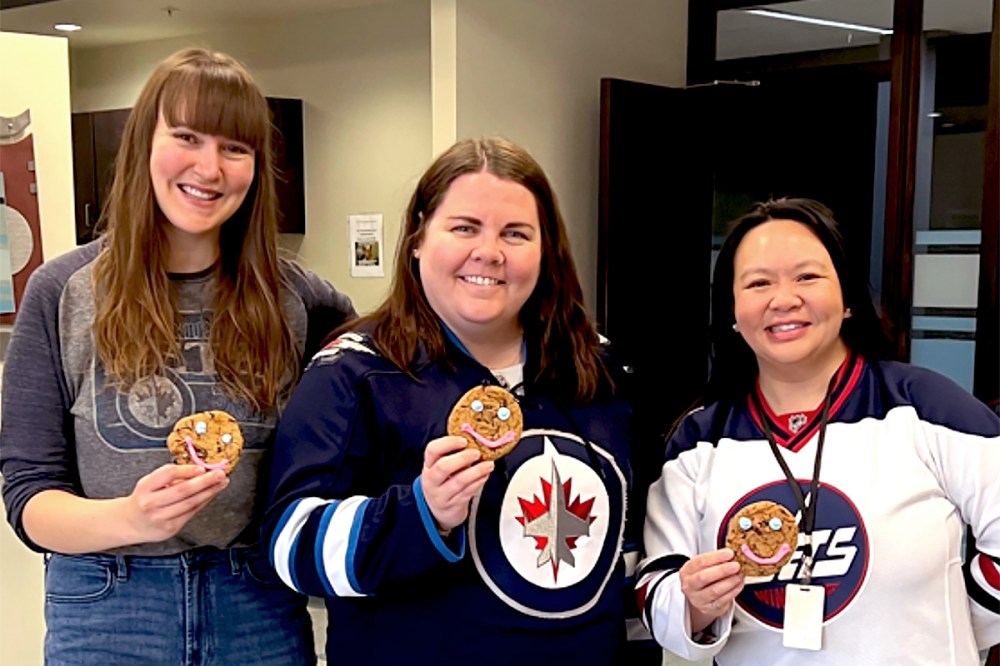 Employees at Westoba Credit Union celebrate with smile cookies during Winnipeg Jets play-off day.