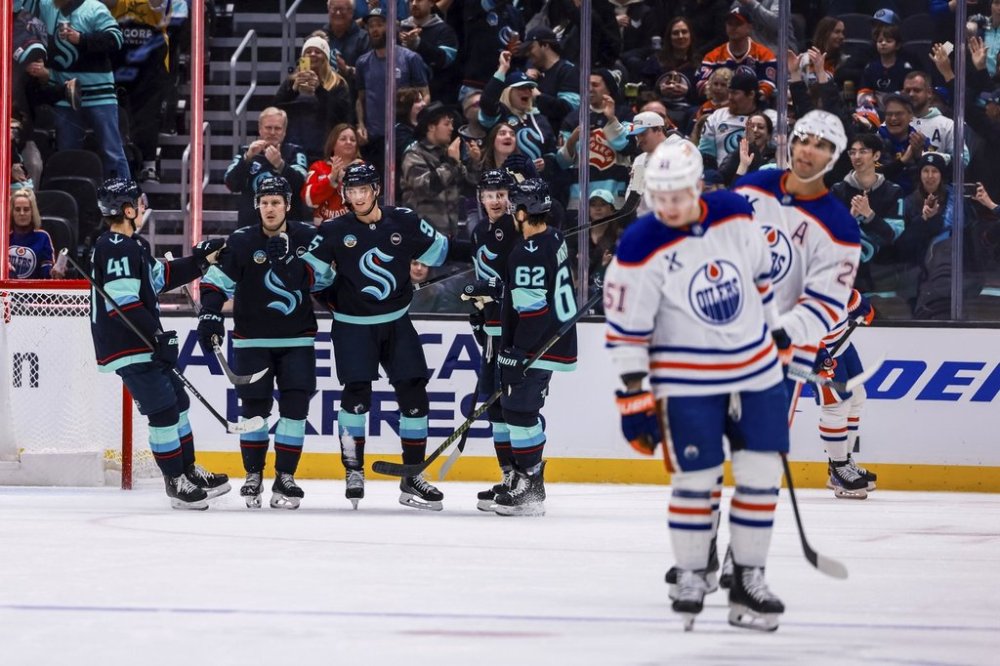 Kraken players celebrate after a goal by Seattle Kraken left wing Andre Burakovsky (95) during the second period of an NHL hockey game against the Edmonton Oilers Thursday, March 27, 2025, in Seattle. (AP Photo/Maddy Grassy)