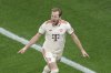 Bayern's Harry Kane celebrates after scoring the opening goal during the Champions League round of 16 second leg soccer match between Bayer Leverkusen and Bayern Munich at the BayArena in Leverkusen, Germany, Tuesday, March 11, 2025. (Rolf Vennenbernd/dpa via AP)