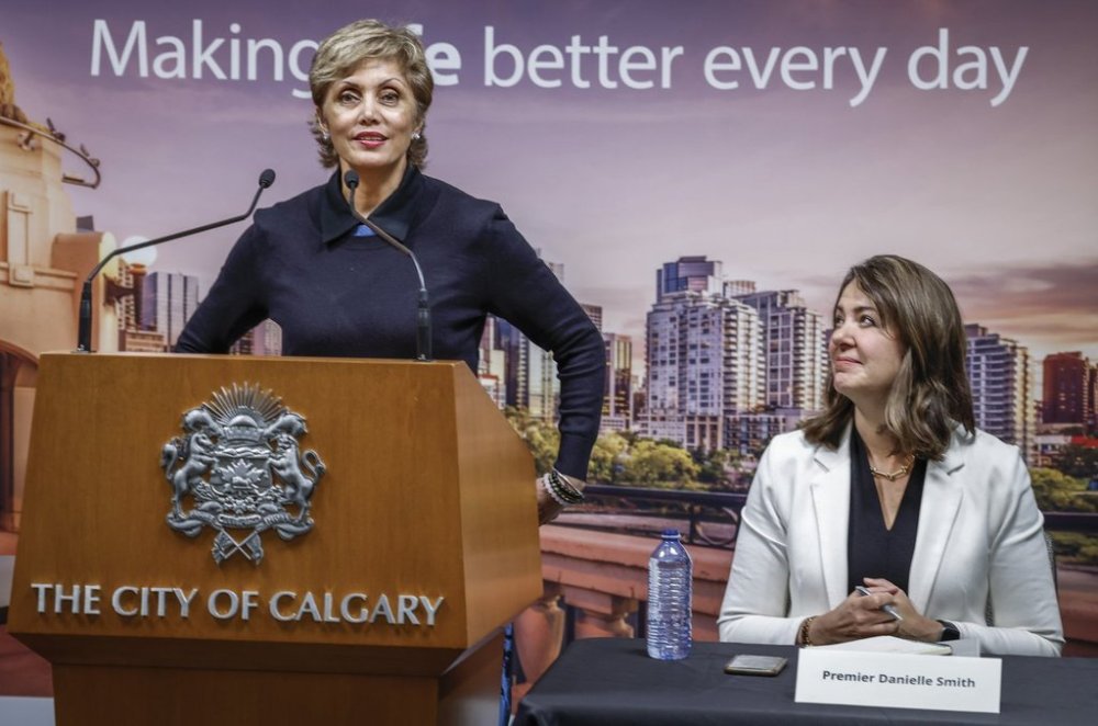 Alberta Premier Danielle Smith, right, looks on as City of Calgary Mayor Jyoti Gondek announces the signing of agreements on the new NHL arena deal in Calgary, Alta., Thursday, Oct. 5, 2023. THE CANADIAN PRESS/Jeff McIntosh