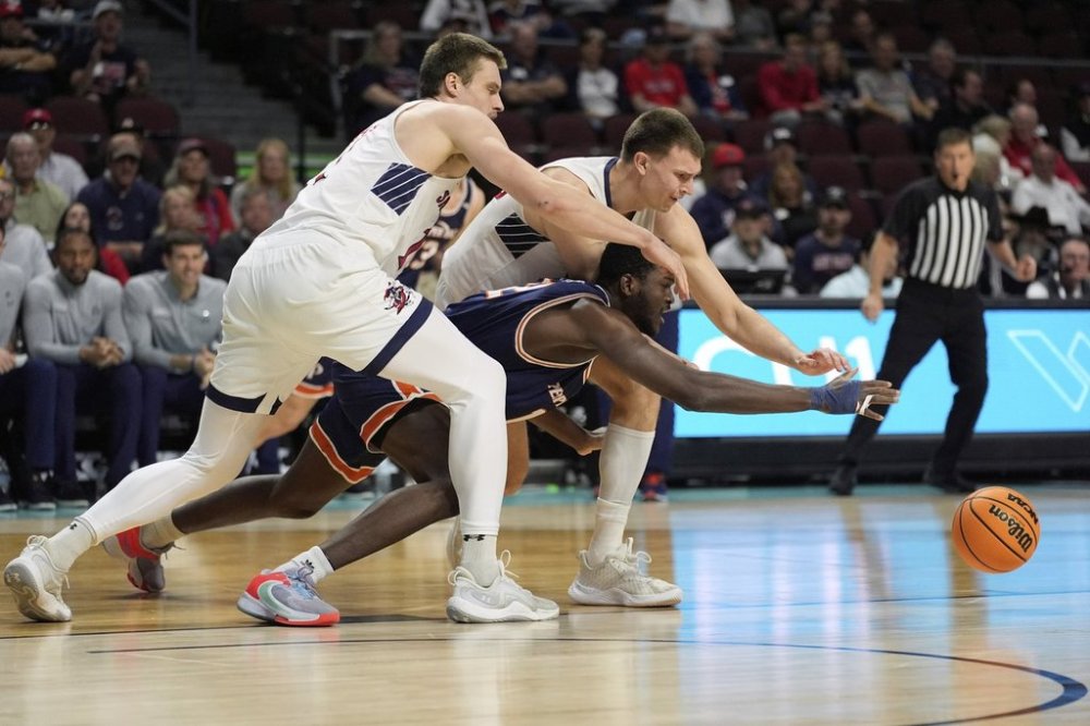 Saint Mary's forward Paulius Murauskas, upper right, Pepperdine forward Boubacar Coulibaly, lower right, and Saint Mary's center Mitchell Saxen, left, scramble for the ball during the first half of an NCAA college basketball game in the semifinals of the West Coast Conference tournament Monday, March 10, 2025, in Las Vegas. (AP Photo/John Locher)