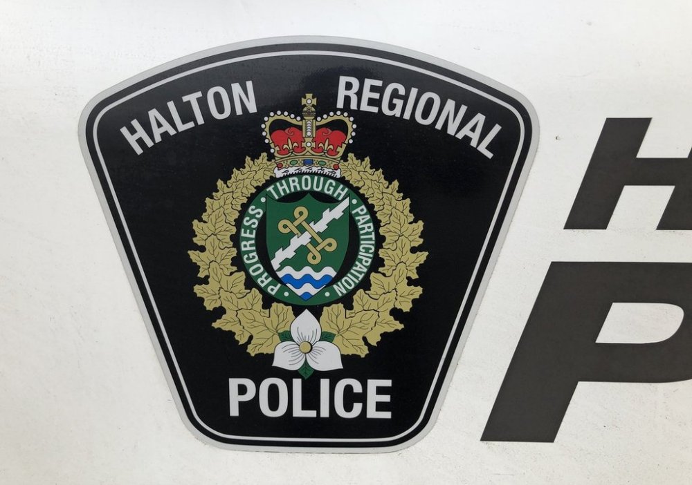 A Halton Regional Police logo is shown on a vehicle in Oakville, Ont., Wednesday, Jan.18, 2023. Police say they are investigating after a man was found dead in a tailor shop in Oakville, Ont., over the weekend. THE CANADIAN PRESS/Richard Buchan