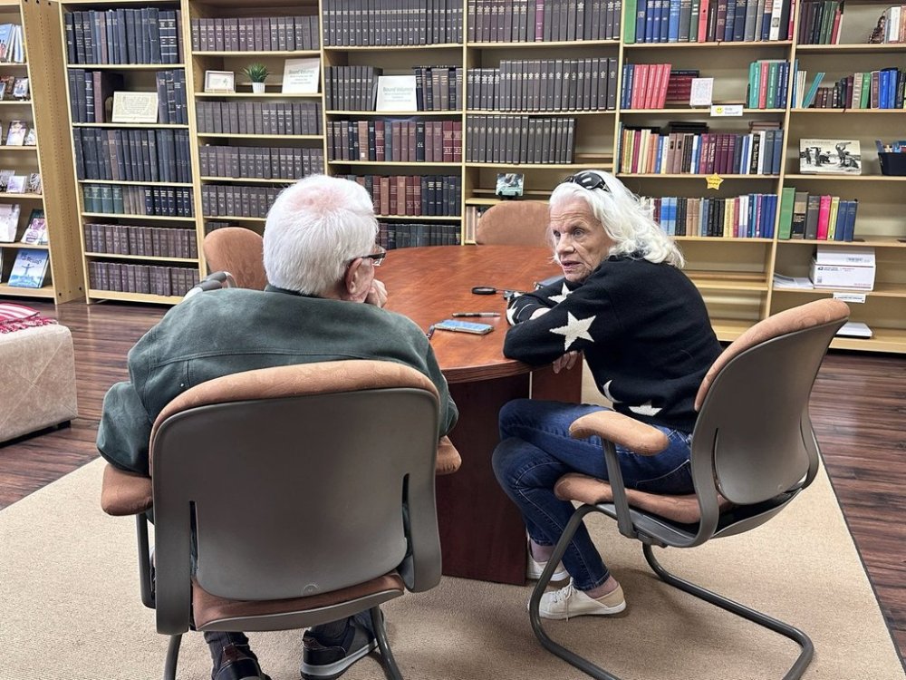 Mike Van Vleck, left, and Gail Dowdle talk while volunteering at the Christian Science Reading Room in downtown Overland Park, Kans., Friday, March 14, 2025. (Kit Doyle/Religion News Service via AP)