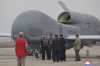 In this photo provided Thursday, March 27, 2025, by the North Korean government, its leader Kim Jong Un, center left in a black jacket, stands by what appeared to be a large reconnaissance drone at an undisclosed location in North Korea, earlier this week. Independent journalists were not given access to cover the event depicted in this image distributed by the North Korean government. The content of this image is as provided and cannot be independently verified. Korean language watermark on image as provided by source reads: 