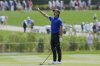 Min Woo Lee yells after hitting his second shot on the ninth hole during the second round of The Players Championship golf tournament Friday, March 14, 2025, in Ponte Vedra Beach, Fla. (AP Photo/Chris O'Meara)