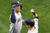 New York Yankees' Aaron Judge, left, celebrates with Ben Rice after hitting a two-run home run off Pittsburgh Pirates pitcher Tim Mayza during the seventh inning of a baseball game in Pittsburgh, Friday, April 4, 2025. (AP Photo/Gene J. Puskar)