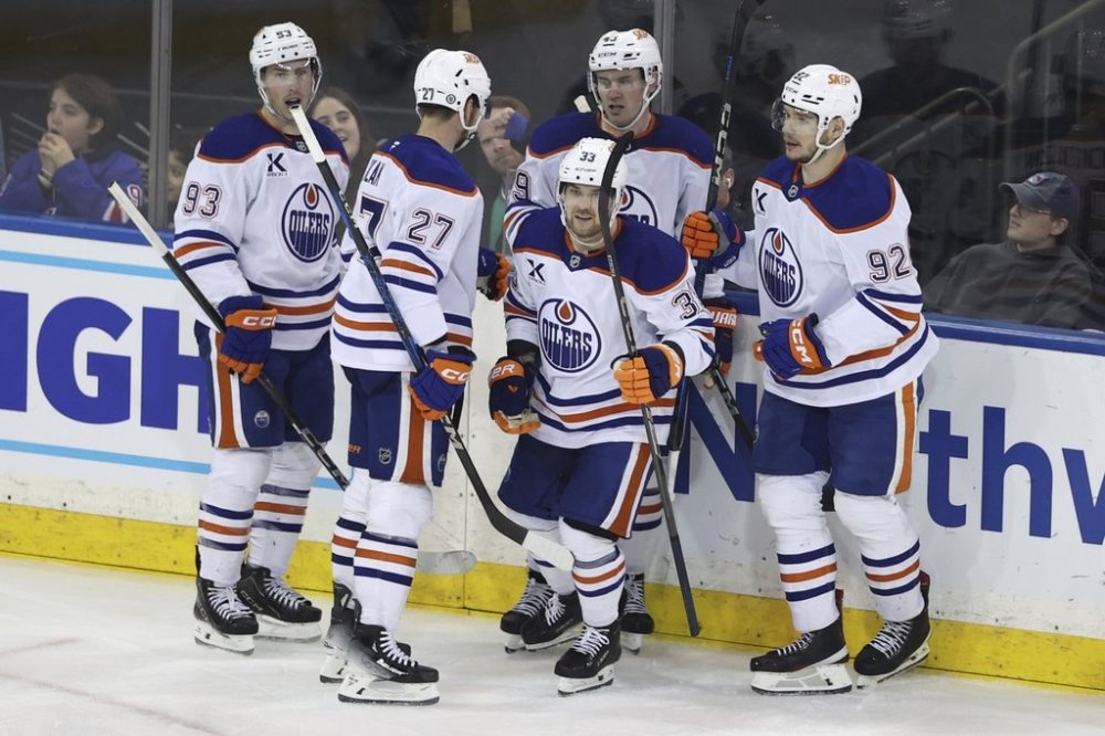From left, Edmonton Oilers' Ryan Nugent-Hopkins, Brett Kulak, Viktor Arvidsson, Ty Emberson and Vasily Podkolzin react after Arvidsson scored during the third period of an NHL hockey game against the New York Rangers Sunday, March 16, 2025, in New York. (AP Photo/Pamela Smith)