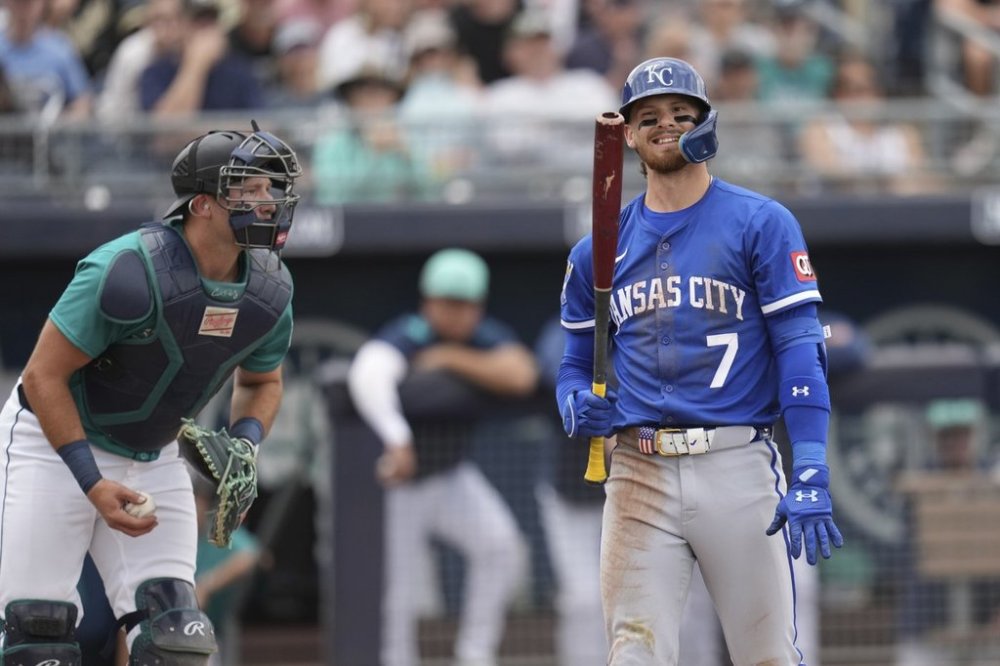 Kansas City Royals' Bobby Witt Jr. (7) grimaces after striking out as Seattle Mariners catcher Cal Raleigh holds the ball during the third inning of a spring training baseball game Wednesday, March 12, 2025, in Peoria, Ariz. (AP Photo/Ross D. Franklin)
