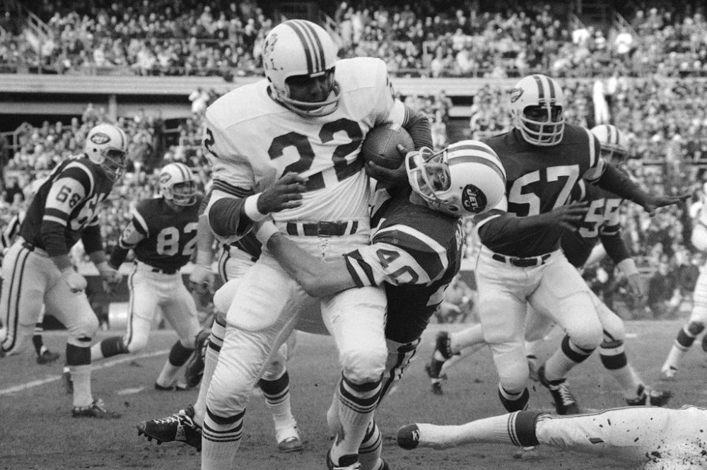 FILE - Boston Patriot Sid Blanks (22) is tackled by New York Jet Mike Battle at Shea Stadium, Sunday Nov. 23, 1970, New York. (AP Photo/Harry Harris,File)
