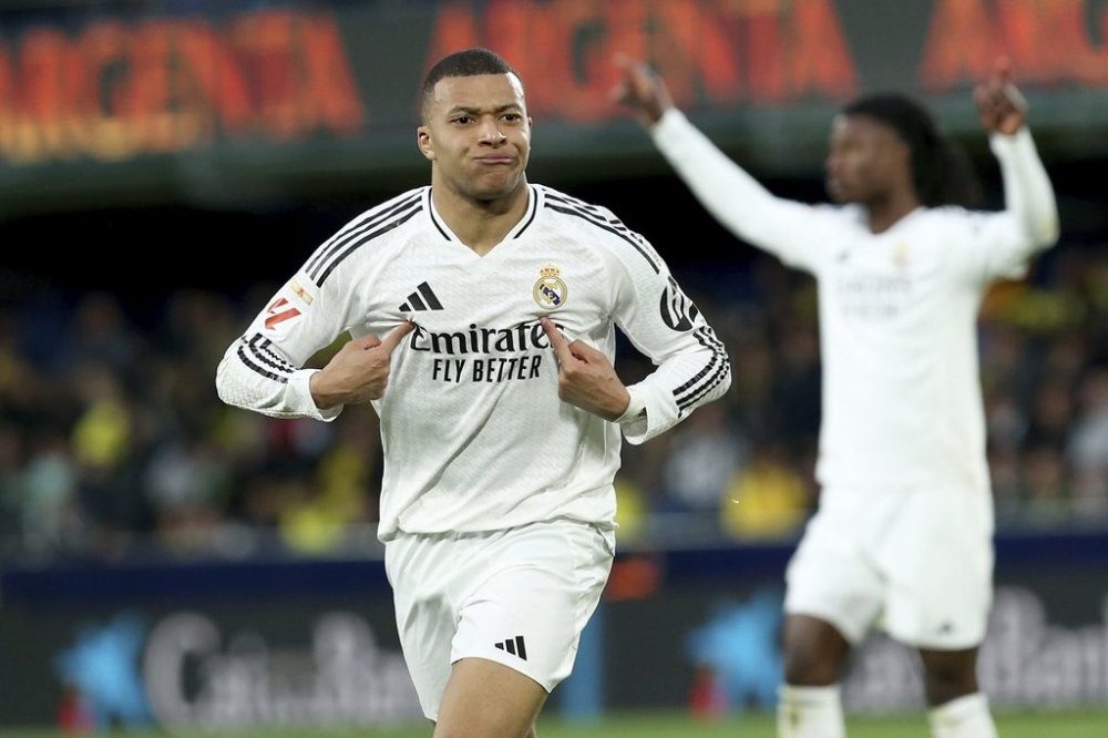 Real Madrid's Kylian Mbappe celebrates after scoring his side's second goal during a Spanish La Liga soccer match between Villarreal and Real Madrid in Villarreal, Spain, Saturday, March 15, 2025. (AP Photo/Alberto Saiz)
