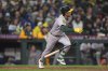 Athletics' Max Muncy follows through on a solo home run, his first major league hit, against the Seattle Mariners during the eighth inning of a baseball game Friday, March 28, 2025, in Seattle. (AP Photo/Lindsey Wasson)