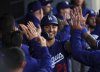 Los Angeles Dodgers' Michael Conforto is congratulated after scoring on a two-run single by Austin Barnes during the fourth inning of a spring training baseball game against Los Angeles Angels, Monday, March 24, 2025, in Anaheim, Calif. (AP Photo/Kevork Djansezian)