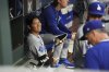Los Angeles Dodgers' Shohei Ohtani smiles in the dugout ahead of a baseball game against the Philadelphia Phillies, Friday, April 4, 2025, in Philadelphia. (AP Photo/Matt Rourke)