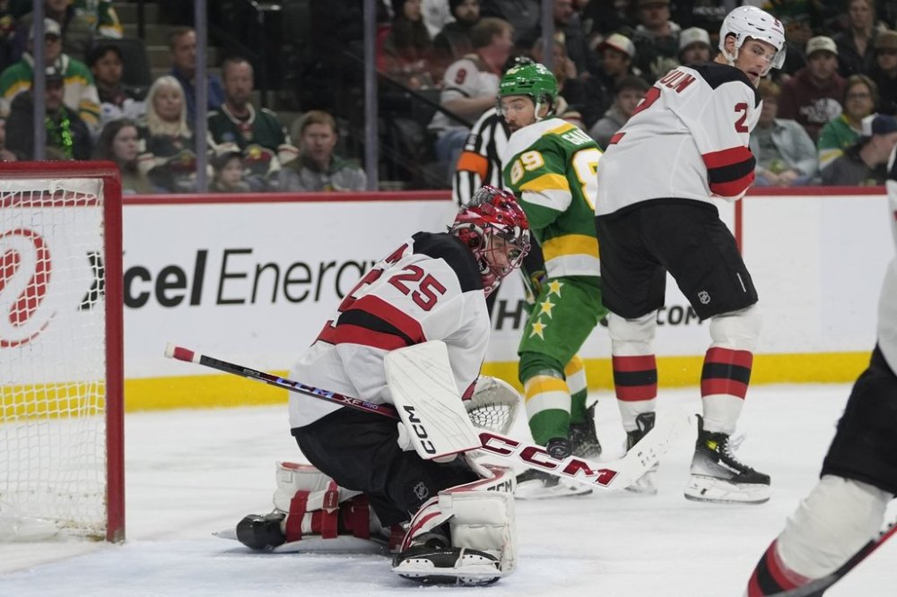 New Jersey Devils goaltender Jacob Markstrom (25) defends against a shot during the first period of an NHL hockey game against the Minnesota Wild, Saturday, March 29, 2025, in St. Paul, Minn. (AP Photo/Abbie Parr)