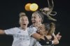 Real Madrid's Athenea del Castillo , centre, celebrates with Real Madrid's captain Olga Carmona, right, after scoring her side's second goal during the Women's Champions League quarterfinal first leg soccer match between Real Madrid and Arsenal at the Alfredo di Stefano stadium in Madrid, Spain, Tuesday March 18, 2025. (AP Photo/Fran Berg)