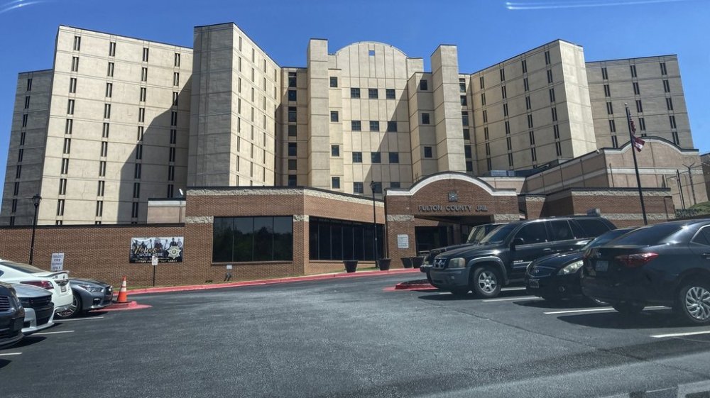 FILE - Vehicles are parked outside the Fulton County Jail, April 11, 2023, in Atlanta. (AP Photo/Kate Brumback, File)