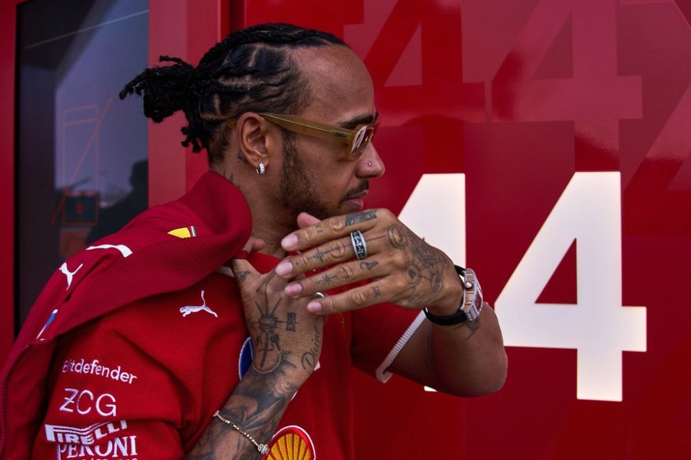 Ferrari driver Lewis Hamilton of Britain gestures as he arrives to his team garage at the Shanghai International Circuit ahead of the Chinese Formula One Grand Prix, in Shanghai, China, Thursday, March 20, 2025. (AP Photo/Andy Wong)