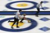 Scotland's Sophie Sinclair, centre, releases the stone during the qualification match against Canada at the World Women's Curling Championship in Uijeongbu, South Korea, Saturday, March 22, 2025. (AP Photo/Lee Jin-man)