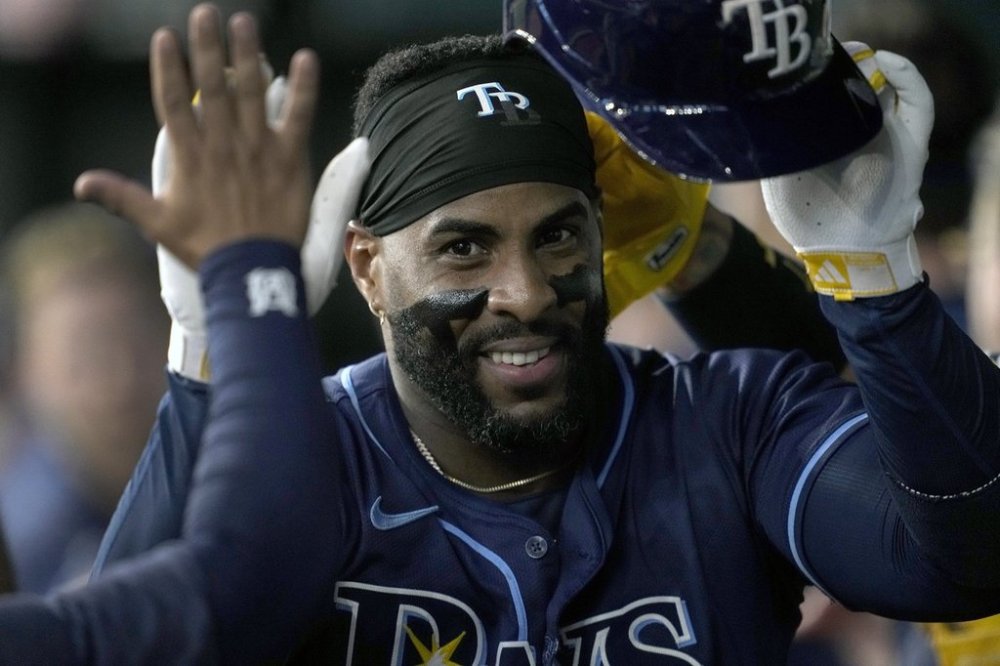 FILE - Tampa Bay Rays' Yandy Diaz celebrates in the dugout after hitting a three-run home run in the seventh inning of a baseball game against the Texas Rangers in Arlington, Texas, Saturday, July 6, 2024. (AP Photo/Tony Gutierrez, File)